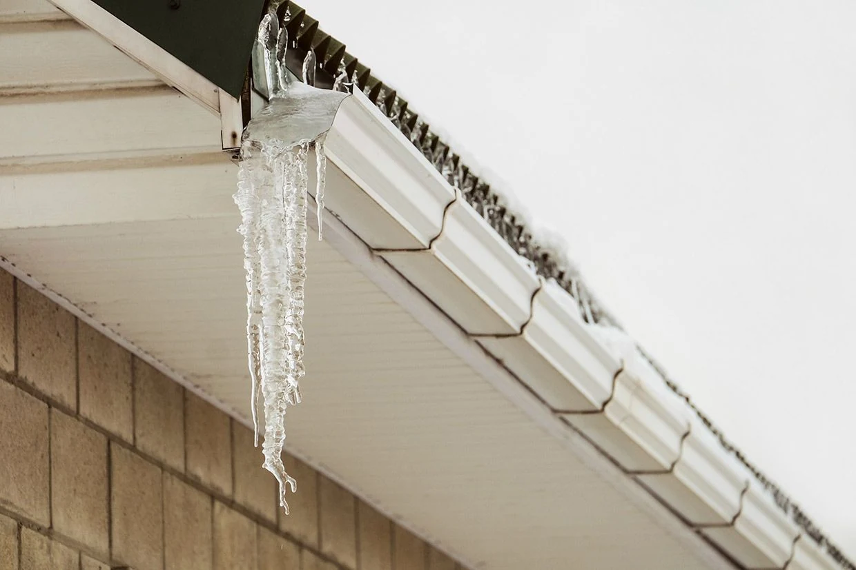 A cleared gutter run draining freely after a full clean-out and flush