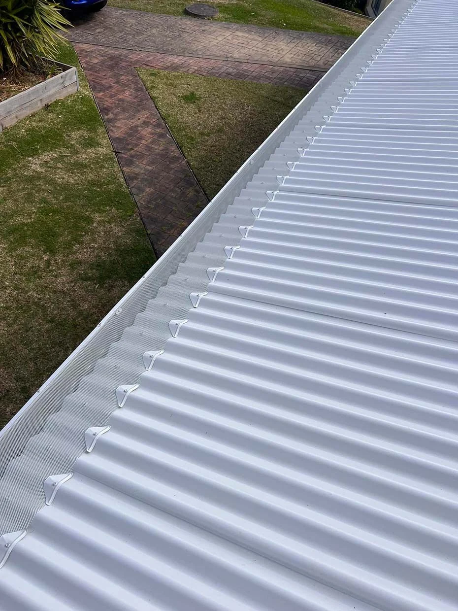 Blocked gutters being flushed clean on a Killarney Vale home